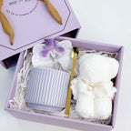 Lavender ribbed ceramic mug gift set with gold spoon, silk orchid, and teddy bear towel in a Precious Gift box