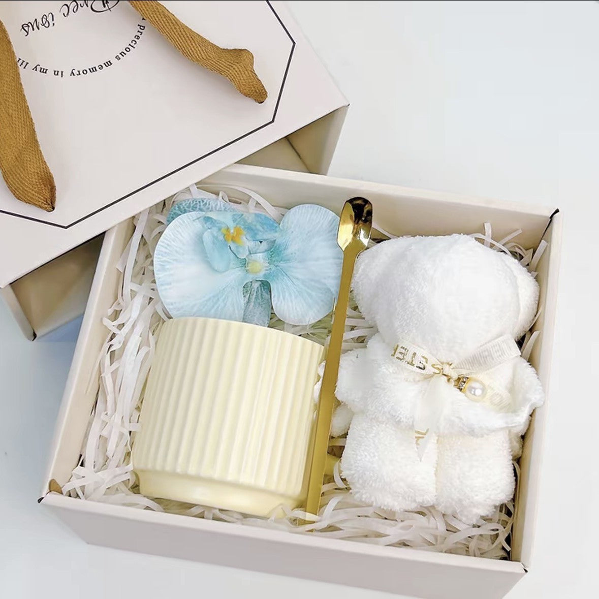 Ivory cream ribbed ceramic mug gift set with gold spoon, silk orchid, and teddy bear towel in a Precious Gift box